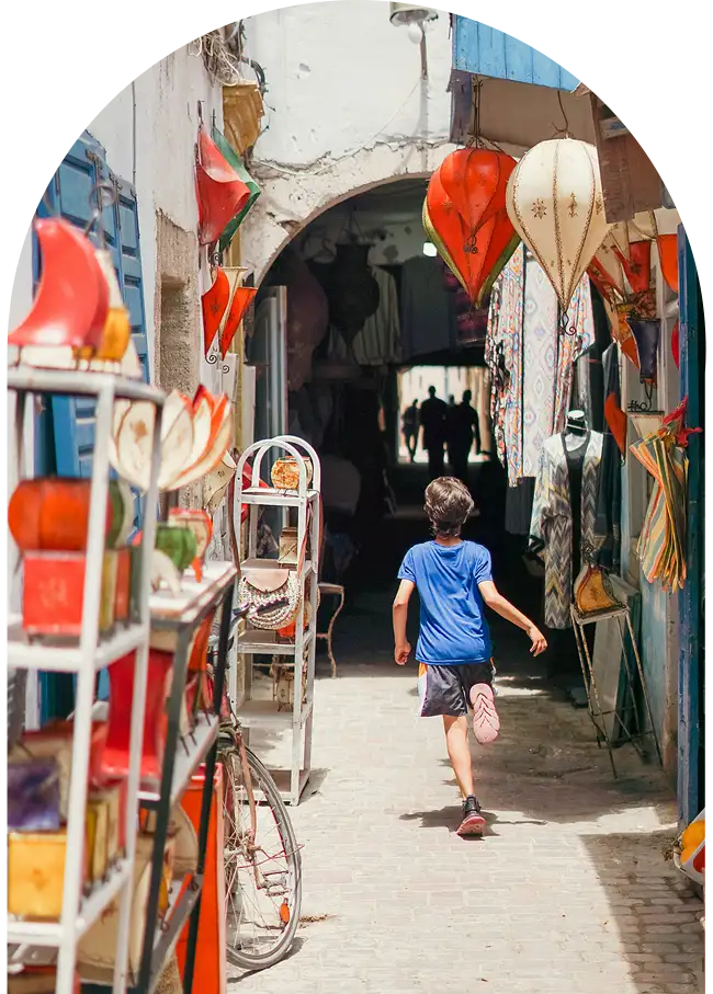 Child running in a shopping alley in Essaouira medina