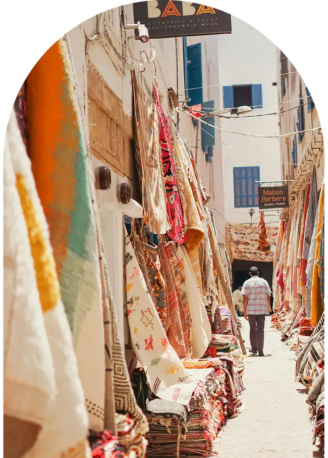 Traditional Moroccan rugs hanging in a shopping alley in Essaouira medina