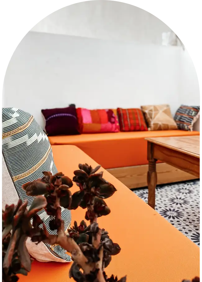 Traditional bench with Moroccan cushions on the sunny terrace