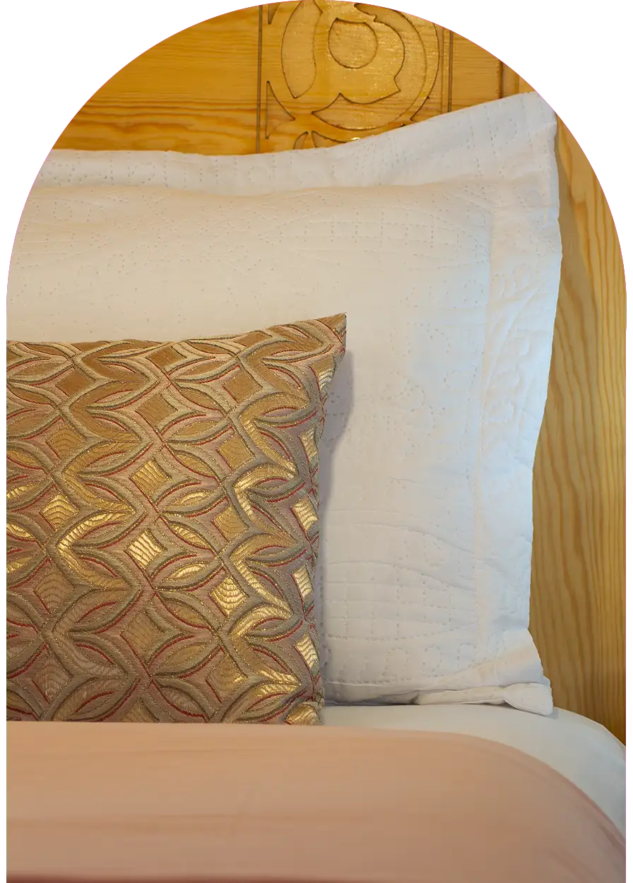 Colorful pillow and traditional carved wooden headboard, Moroccan decoration detail